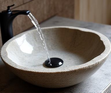 Stunning hand-carved natural stone basin with flowing water